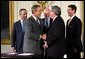 President George W. Bush shakes the hand of Congressman Bill Thomas, R-Calif., after signing the Jobs and Growth Tax Reconciliation Act of 2003 in the East Room Wednesday, May 28, 2003. Also pictured are, from left, Secretary of Commerce Donald Evans, Secretary of the Treasury John Snow and Senate Majority Leader Bill Frist, R-Tenn. White House photo by Eric Draper. 