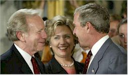 President Bush shares a laugh with Democratic U.S. Senator Joe Lieberman from Connecticut, and New York Senator Hillary Clinton 